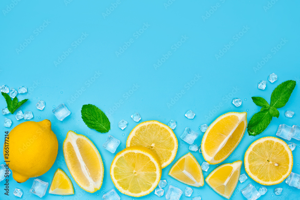 Lemon slices with ice and mint on blue background with copy space. Lemonade or mojito set top view. Lemon slices with ice and mint on blue background with copy space. Lemonade or mojito set top view.