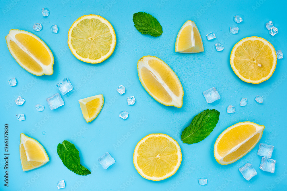 Lemon set with ice cubes and mint leaves on blue background. Different slices of lemon top view. Mojito or lemonade ingredients. Lemon set with ice cubes and mint leaves on blue background. Different slices of lemon top view. Mojito or lemonade ingredients.