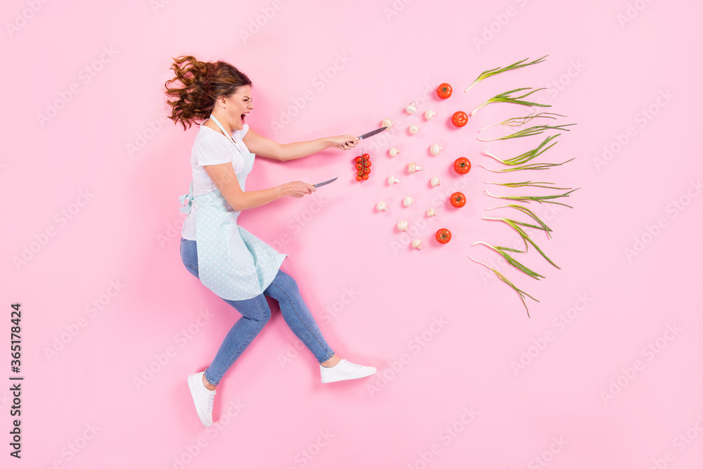 Top above high angle full size profile side photo of crazy furious house wife woman cant prepare tasty dish flat lay hold knife fight eco bio vegetables isolated pastel color background