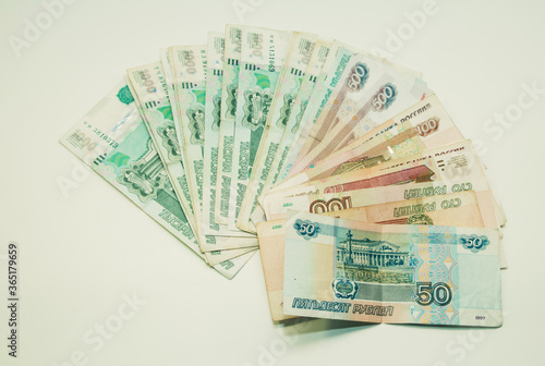 Money notes of one thousand, five hundred, one hundred and fifty rubles are on a white background