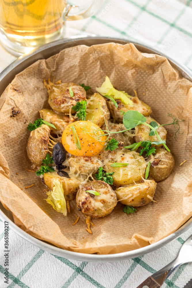fried potatoes with yolk and cheese with glass of beer on fabric napkin fried potatoes with yolk and cheese with glass of beer on fabric napkin