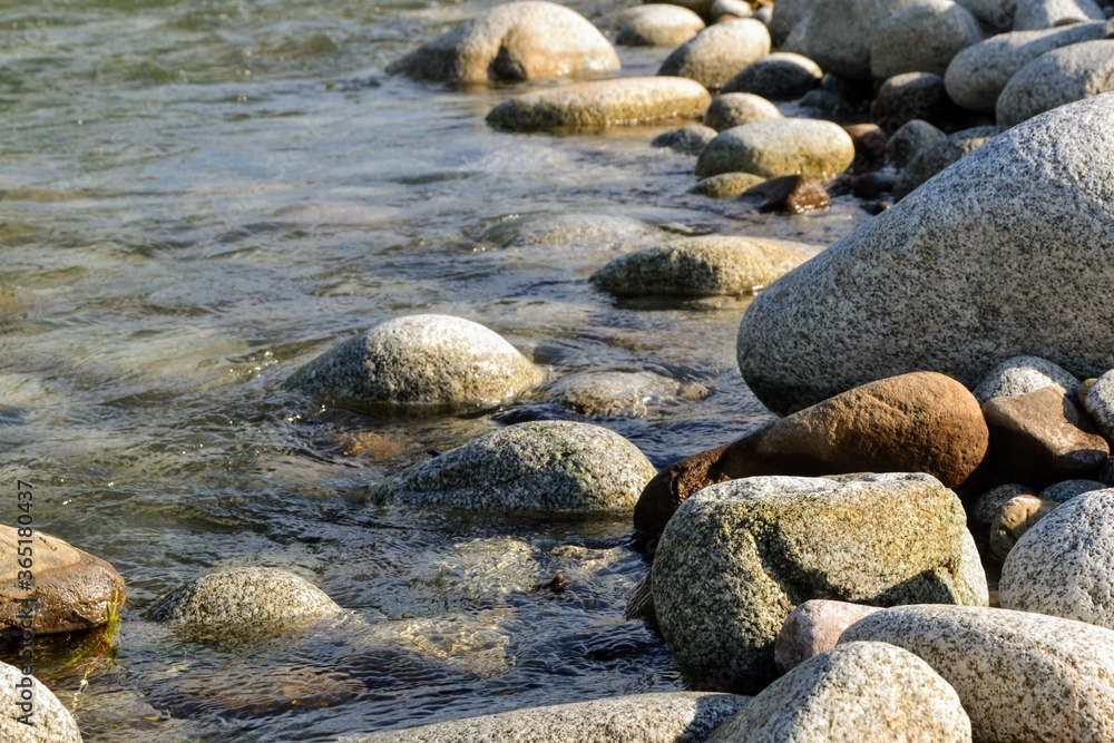 Huge stones on the river bank. River stones and clean, clear water of the river. Bialka River, Poland Huge stones on the river bank. River stones and clean, clear water of the river. Bialka River, Poland