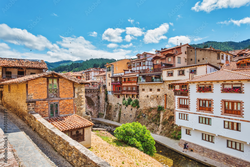 Views of the medieval town of Potes with hanging houses and the Deva river, Cantabria, Spain.