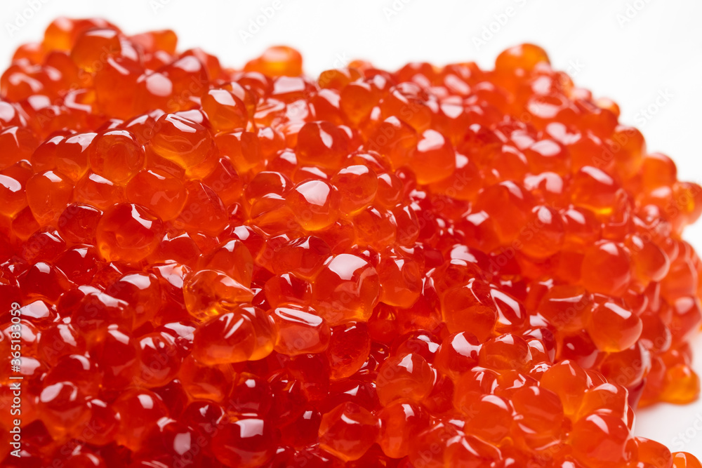 Red caviar isolated on a white background. Gourmet food close up. Macro shot, shallow depth of field Red caviar isolated on a white background. Gourmet food close up. Macro shot, shallow depth of field