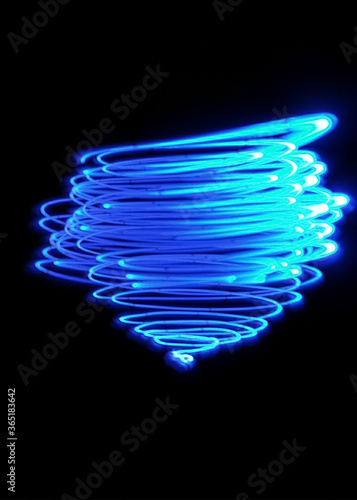 Light painting design. Combination of sky blue and white light against a black background 