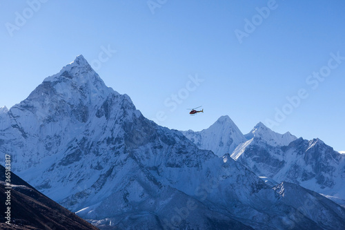 Helicopter in Himalayas. Mt. Ama Dablam on sunny day. Everest base camp trek, Nepal.
