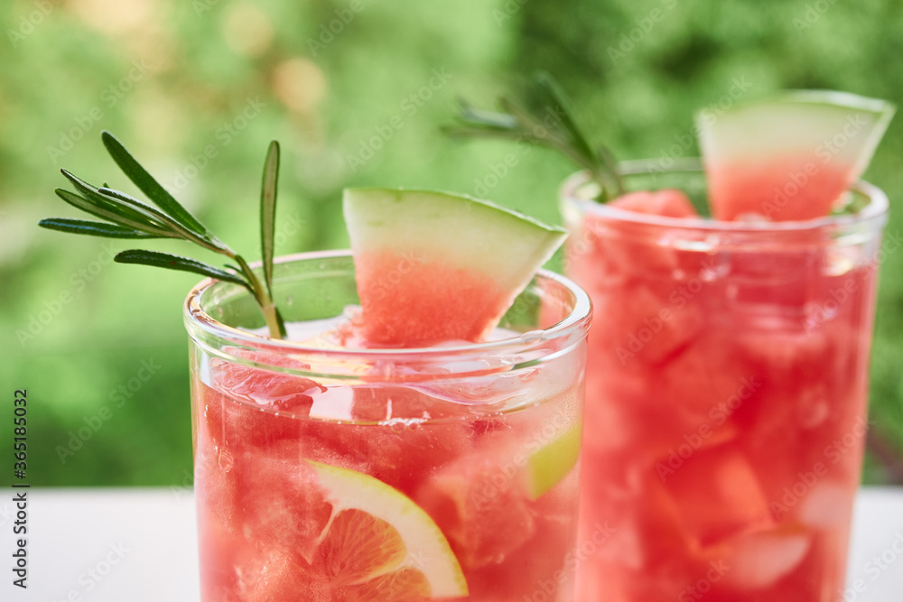 Summer refreshing drink with ice, slices of watermelon, lemon, rosemary, Summer refreshing drink with ice, slices of watermelon, lemon, rosemary,