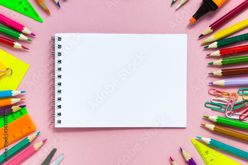 School colorful supplies and paper note on pink, flat lay, top view, back to school, copy space, mockup