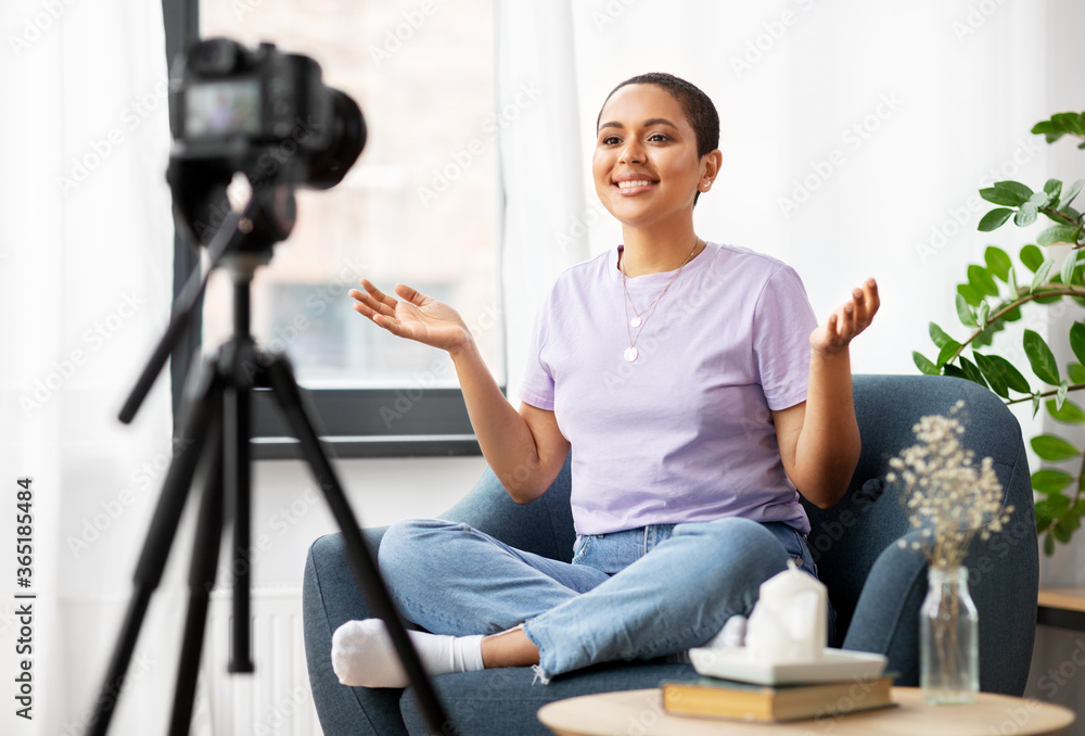 blogging, videoblog and people concept - happy smiling african american female video blogger with camera videoblogging at home blogging, videoblog and people concept - happy smiling african american female video blogger with camera videoblogging at home