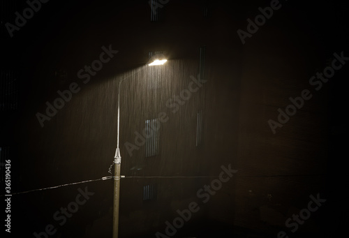 Fotografie Heavy rain under Night Street lamp lights , Rainstorm,Grained Image