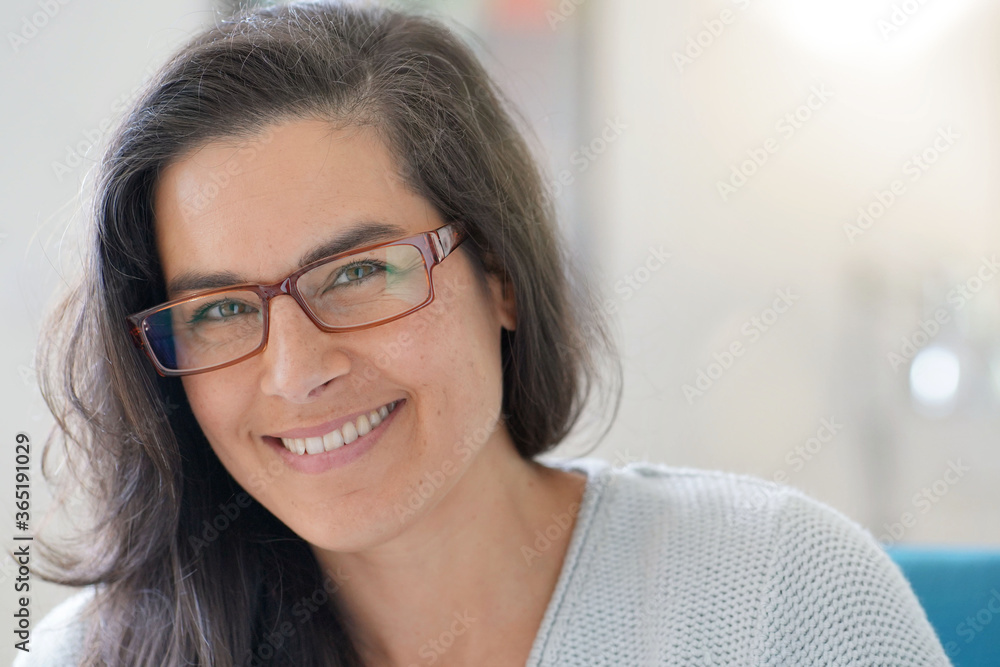 Portrait of beautiful 40 year old woman with long dark hair wearing eyeglasses Stock Photo Adobe Stock