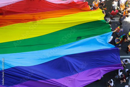 Revelers fill the streets holding a giant rainbow flag during the annual gay pride parade in Paulista avenue, Sao Paulo, Brazil.