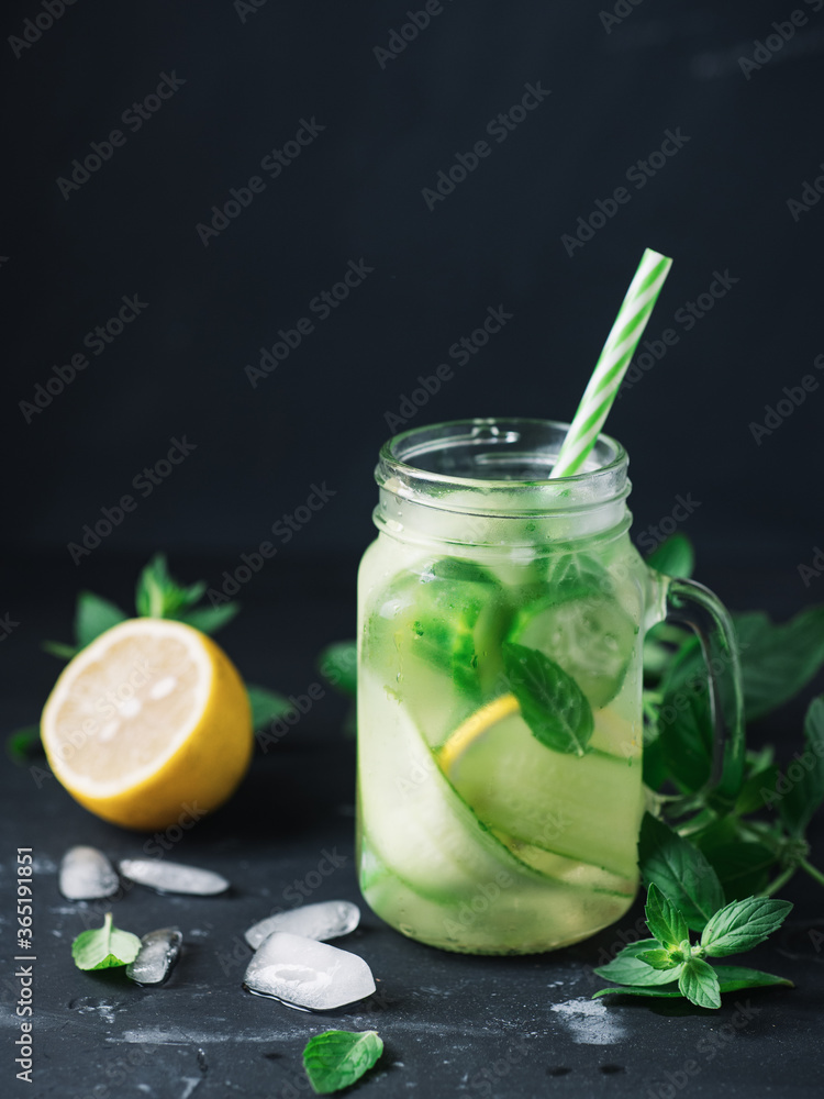 Fototapeta premium Close-up detox water with cucumber, mint and lemon in a jar . Summer cold healthy drink