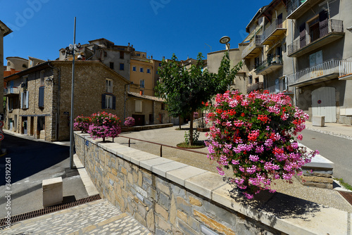 Fototapeta Naklejka Na Ścianę i Meble -  Town and geranium flowers at Sisteron, a commune in the Alpes-de-Haute-Provence department in the Provence-Alpes-Côte d'Azur region in southeastern France 