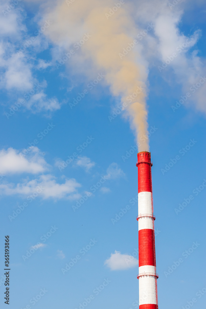 Industrial chimneys smoke smog on blue sky. Air pollution disaster concept. Day of the Planet Earth. Vertical frame
