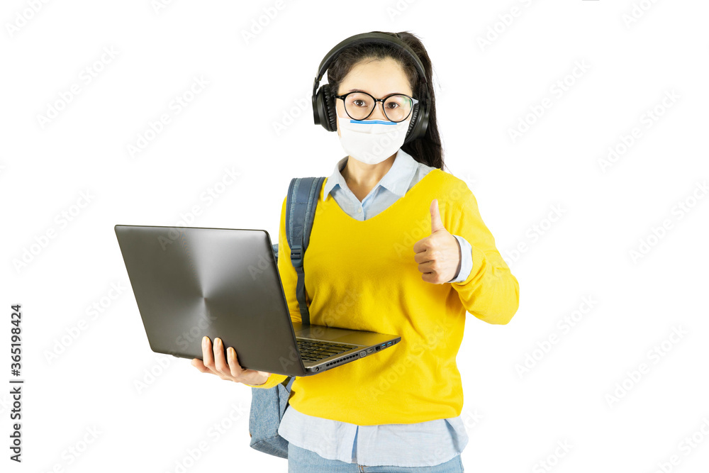 Young asian student woman in yellow shirt and glasses wearing medical face mask,carrying a bag and laptop to go to school Under the outbreak of the virus isolated on white background Young asian student woman in yellow shirt and glasses wearing medical face mask,carrying a bag and laptop to go to school Under the outbreak of the virus isolated on white background