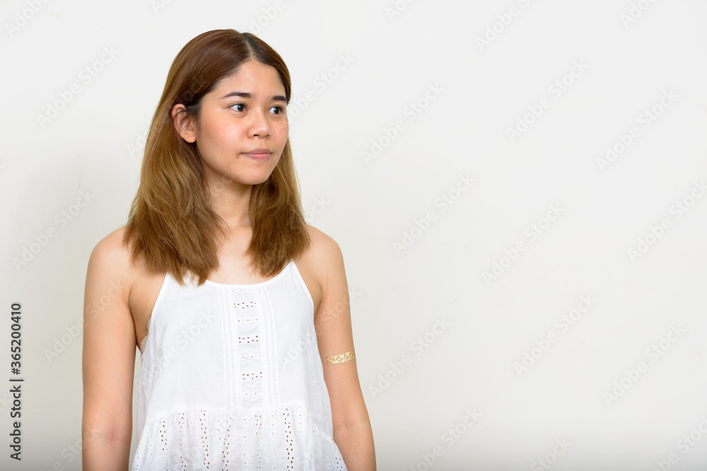 Portrait of young Asian woman against white background Portrait of young Asian woman against white background