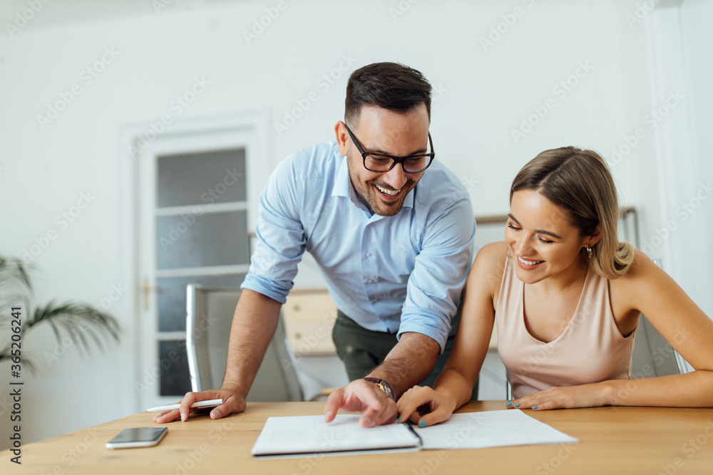 Smiling colleagues working on business ideas together, portrait. Smiling colleagues working on business ideas together, portrait.