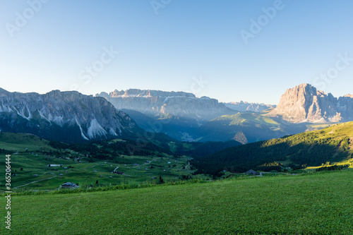 Summer morning view of Seceda Odle Puez mountain and wooden chalets in Dolomites, Trentino Alto Adige, South Tyrol, Italy