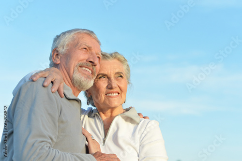 Close-up portrait of happy senior couple hugging