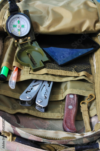 Compass, knife and multitool are in the backpack