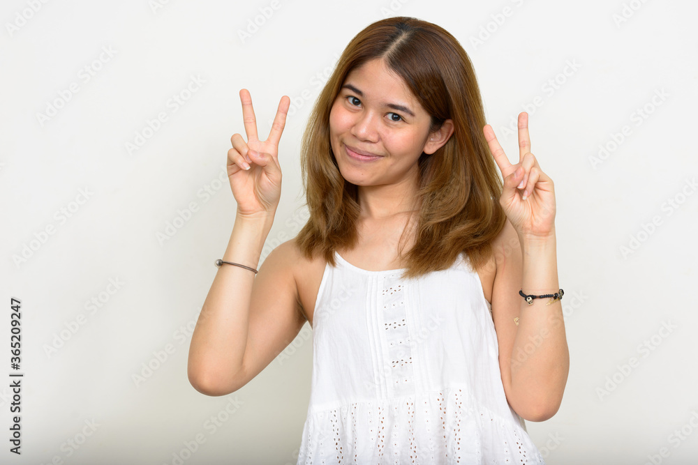 Portrait of young Asian woman against white background Portrait of young Asian woman against white background