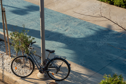 The road and the bike locked up to a pole