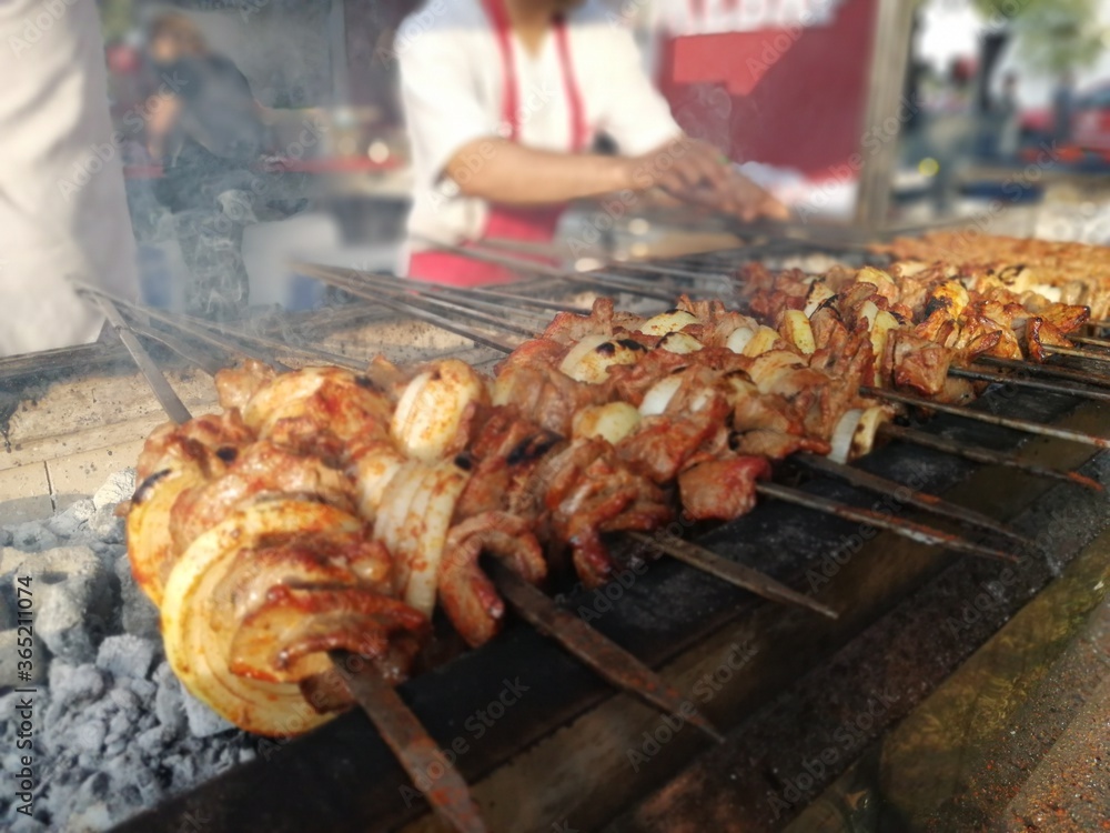 Shashlik preparing on a barbecue grill over charcoal. Shashlik or Shish kebab popular in Eastern Europe. Shashlik preparing on a barbecue grill over charcoal. Shashlik or Shish kebab popular in Eastern Europe.