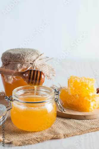 Honey in a jar on wooden rustic background