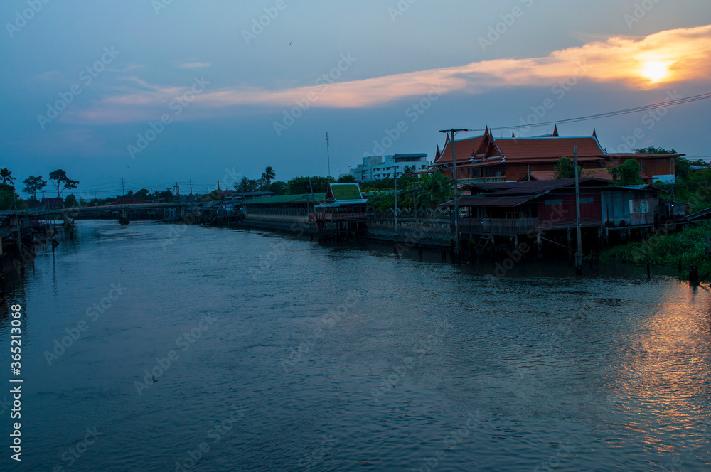 A beautiful sunset in the evening behind an old community beside the Bangkok Noi canal in Nonthaburi, Thailand.