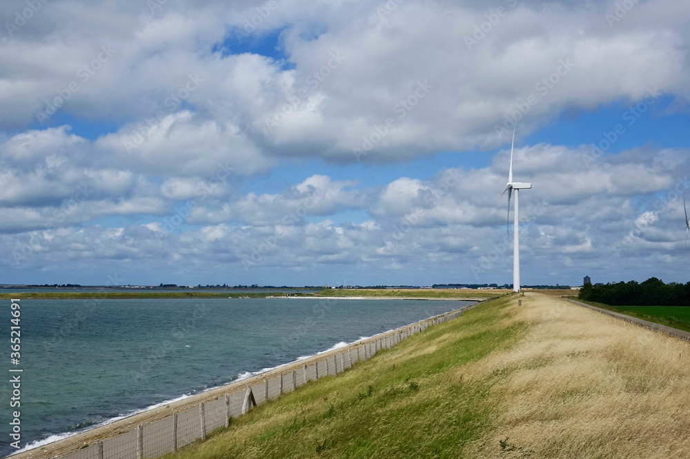 Netherlands. Zeeland. A dike with windmill in Serooskerke Netherlands. Zeeland. A dike with windmill in Serooskerke