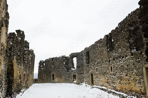 Mukachevo castle in sunny weather on a hill. Notes on architecture. Remains of a fortress in Mukachevo. Harmonious sky and sunny weather in Transcarpathia. Ruin. Palanok Castle. photo