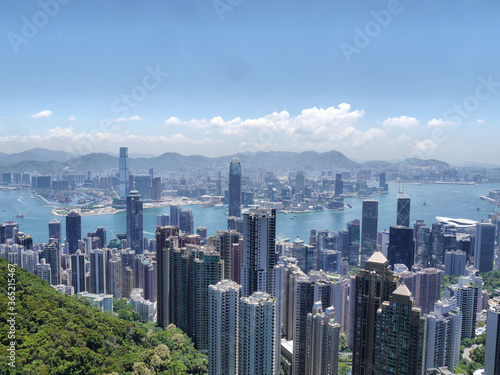 Hong Kong Skyline With Tall High Rise Skyscraper Buildings, Victoria Harbour and Mountains - View From Victoria Peak (Kowloon and Hong Kong Island)