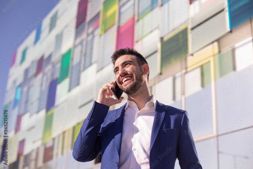 Portrait of a young executive with suit and cell phone Portrait of a young executive with suit and cell phone