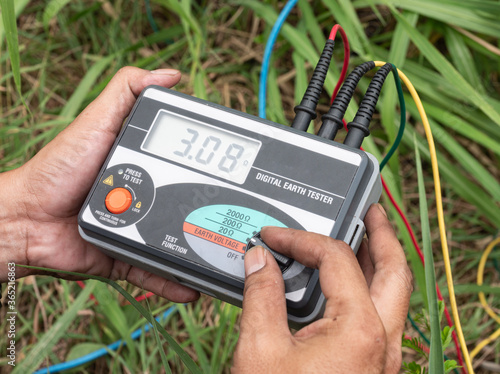Konstfotografi The engineer is using digital earth tester for measure insulation resistance between the electrical part with grounding or earth to protect short circuits