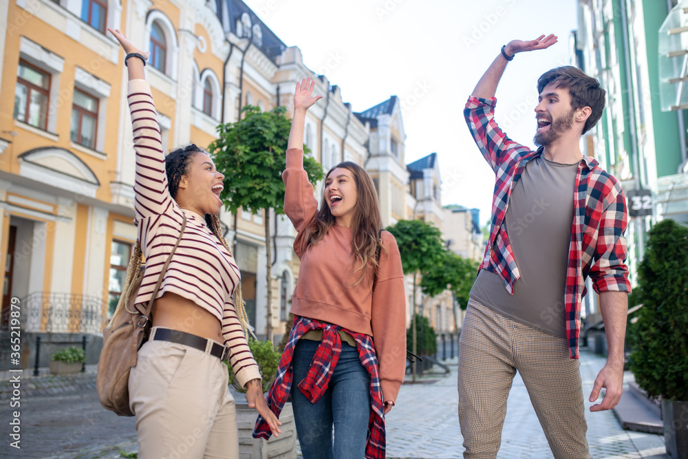 Three young friends having fun in the city.