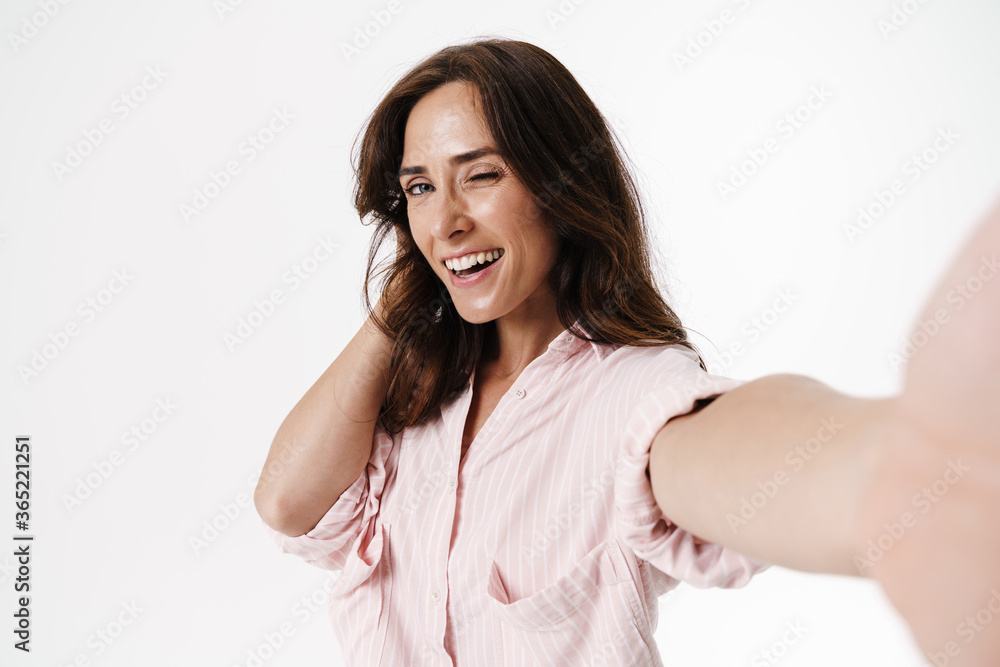 Image of happy nice woman winkingwhile taking selfie photo Image of happy nice woman winkingwhile taking selfie photo