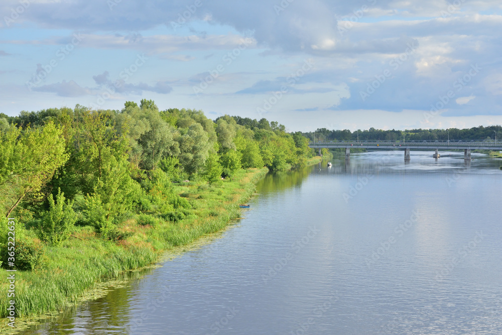 River meanders on a cloudy day, clouds in the sky.