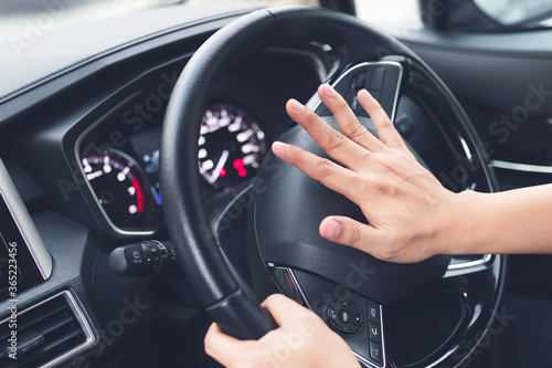 Fotografia man pushing horn while driving sitting of a steering wheel press car, honking sound to warn other people in traffic concept