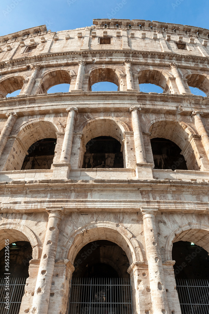 Architectural details of the facade of the Colosseum (Coliseum) or Flavian Amphitheatre, the largest Roman amphitheater located in city of Rome, Italy