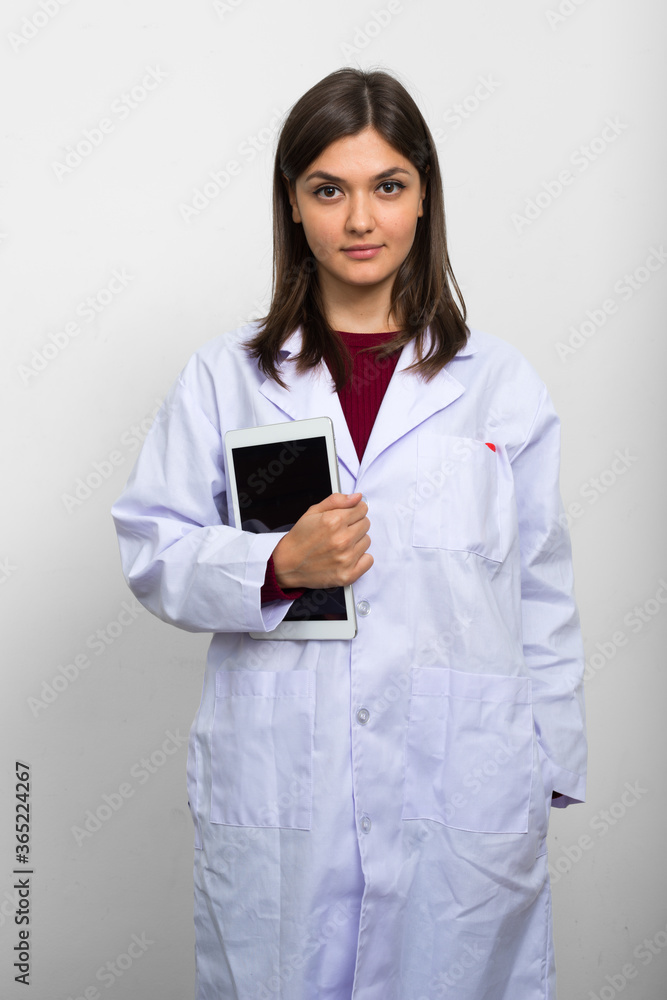 Portrait of young beautiful woman doctor with brown hair