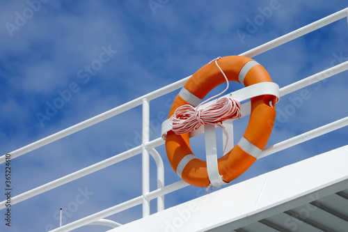 Lifebuoy hanging on a Iron railings of the boat With a background sky security concept , Ideal for use in the design put images and insert text