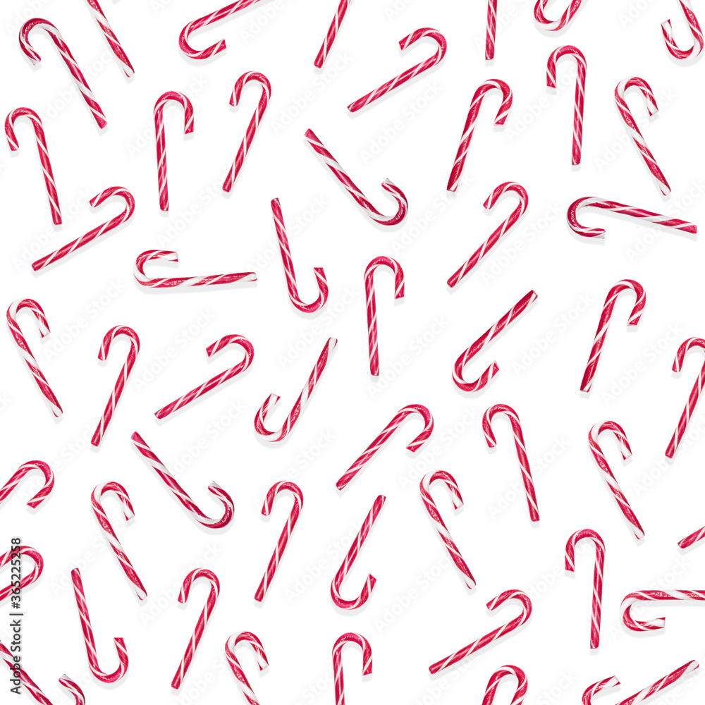 Multiple Christmas candy canes on a white isolated background white / red Christmas candies. candy pattern, pattern, greeting card, wallpaper, wrapping paper Multiple Christmas candy canes on a white isolated background white / red Christmas candies. candy pattern, pattern, greeting card, wallpaper, wrapping paper