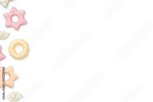 Multiple colored Christmas meringue candies on the left side of the frame on a white isolated background green / orange / white and pink Christmas candies. Space for text