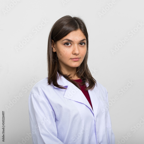 Portrait of young beautiful woman doctor with brown hair