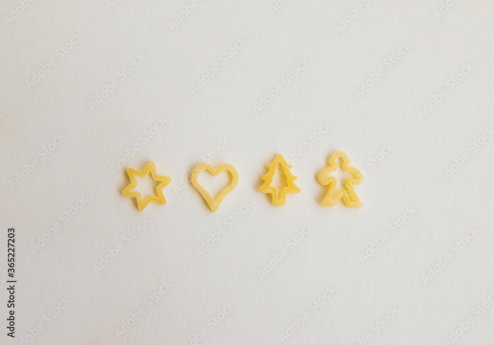 Macaroni in the form of different figures.Human figures, hearts and Christmas trees.Small figures made of durum wheat. Macaroni in the form of different figures.Human figures, hearts and Christmas trees.Small figures made of durum wheat.
