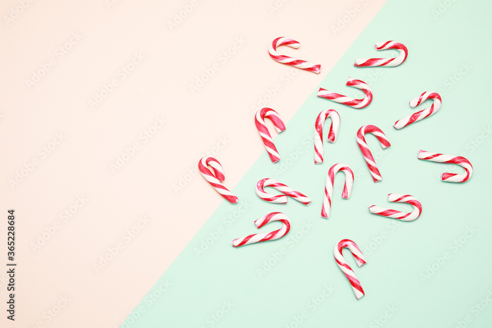 View from the top at white and red striped candy lollipop isolated on color background View from the top at white and red striped candy lollipop isolated on color background