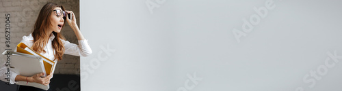 Obraz na plátne Business lady indoors holding folders looking aside