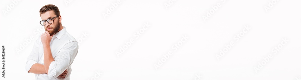 Handsome young bearded man standing over white wall Handsome young bearded man standing over white wall