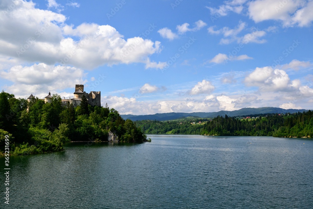 Lake Czorsztyn and medieval castle in Niedzica. The beauty of nature and architecture in Southern Poland. Medieval Castle in Niedzica, built in 14th century and artificial Czorsztyn Lake